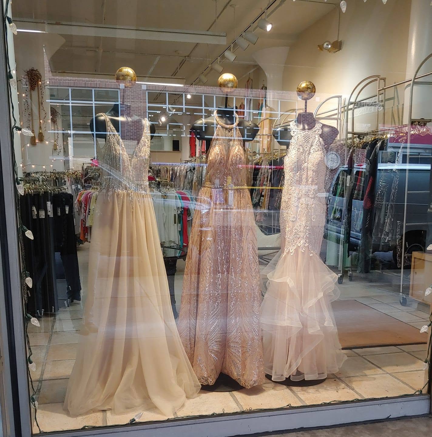 Three champagne gowns in the Rain Tree window